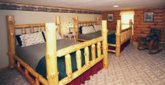 This large room has 1 King and 1 Queen hand-made Wisconsin native white pine log beds.